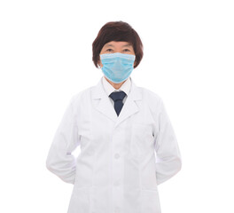 Female doctor wearing a mask standing with her hands behind her back in front of white background
