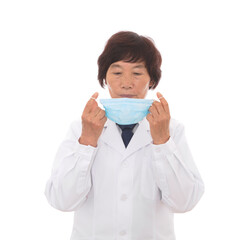 Female doctor demonstrating the correct wearing of a mask