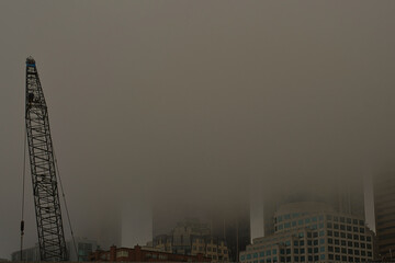 Fototapeta premium 2020-10-10 DOWNTOWN SEATTLE SKYLINE IN FOG WITH A CRANE IN THE FOREGROUND
