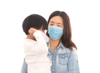 With the help and guidance of mother, the child is wearing a mask