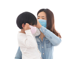 With the help and guidance of mother, the child is wearing a mask