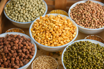 Various sources of vegetable protein beans, lentils, peas, chickpeas, mung bean in bowls. Indian...