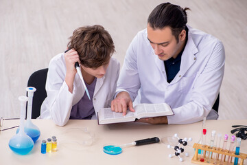 Young father and son chemists in the lab