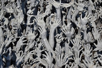 Thailand, in front of the White Temple in Chiang Rai there are many of desperate hands. This symbolises hell - the endless pit of desires and human cravings, according to Buddhism. 