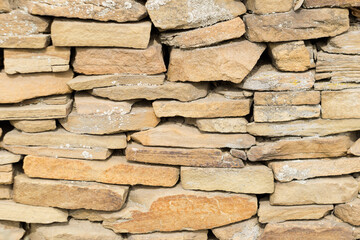 Stone texture background, decorative old cracked stone wall surface. Horizontal orientation, copyspace