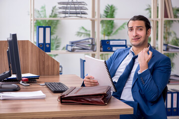 Young male employee businessman at workplace