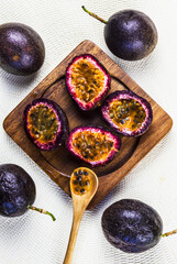 passion fruits cut on wooden board