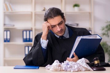 Young male judge working in courthouse