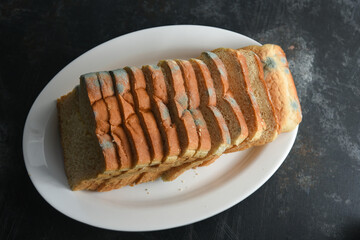 not fresh mouldy slice of stale bread. Mould on sliced bread with harmful bacteria. Fungal mold Spoiled, moldy inedible food Rotten and uneatable. modify fungus into an anti-virus chemical.