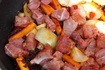 goulash with carrots and onions in a pan