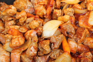 goulash with carrots and onions in a pan