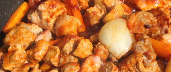 goulash with carrots and onions in a pan
