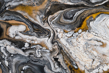 Liquid marble texture. Abstract mixing acrylic paints. Black and white color with golden veins. Top view