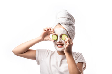 10 years old preteen chilling making clay facial mask nd cucumber slices on eyes. Teenage girl...