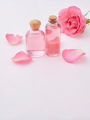 Aromatherapy oil bottles and pink rose