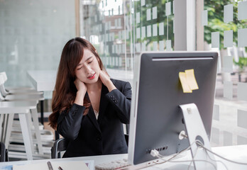 Beautiful and cute Asian businesswoman has pain in the neck due to long periods of hard work in the office, Office Syndrome  concept.