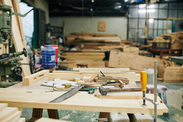 Wooden workbench with various tools in carpentry shop