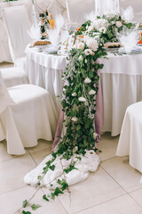 Wedding floral decor in warm pastel colors for the wedding ceremony. Floral details.