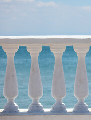 White concrete railing by the sea