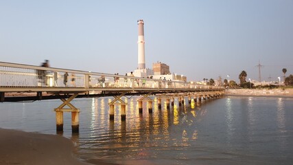 People passing the bridge by foot and bicycles