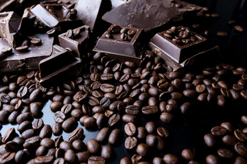 dark organic chocolate and coffee beans on concrete background