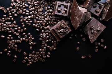 dark organic chocolate and coffee beans on concrete background