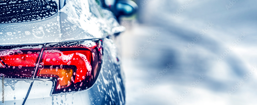 Canvas Prints Manual car wash with white soap, foam on the body. Washing Car Using High Pressure Water.