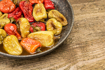 Fried and tasty peppers in the pan with copy space