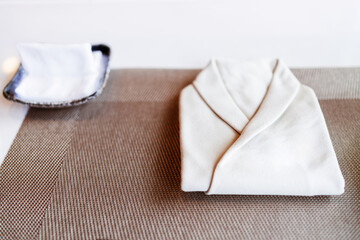 The folded white napkin in Omakase chef uniform shape with finger napkin on the Omakase counter bar.