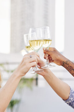 Close-up image of people clinking glasses of champagne at party