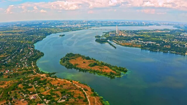 Aerial view over beautiful suburb with a wide river with  privat houses.  Top view over  a  people settlement near water.