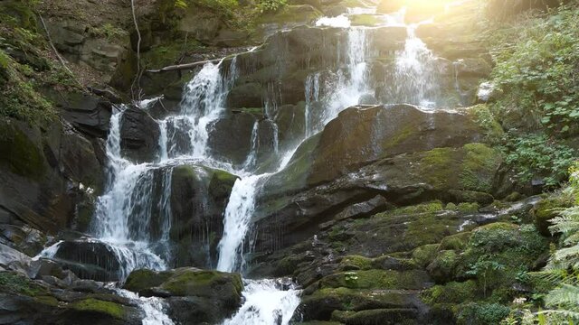 Beautiful waterfall and sun in Carpathian Mountains, Ukraine