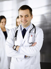 Professional middle aged doctor with a stethoscope and crossed arms at work in a clinic. Perfect medical service in a hospital. Medicine and healthcare concept