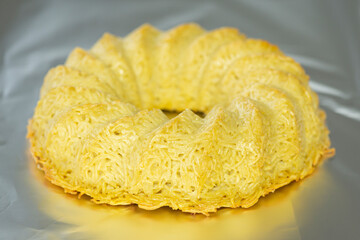 Traditional Jewish dish named Kugel made of noodles, eggs salt and pepper on a aluminium foil