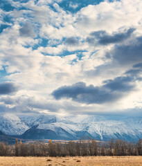 panoramic view of picturesque snowy mountains tops on blue sky background