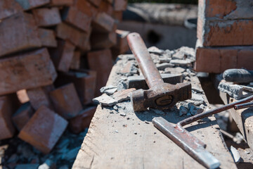 Scrap bricks. Construction is in progress. Destroy a brick wall. Engage in construction. Bricks with cement