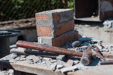 Scrap bricks. Construction is in progress. Destroy a brick wall. Engage in construction. Bricks with cement