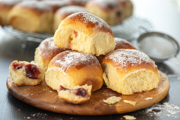 Sweet bread rolls with cherri filling and powdered sugar on top