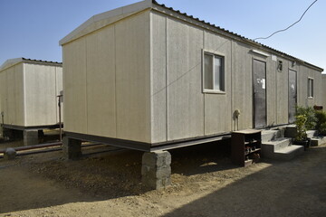 Obraz na płótnie Canvas Portacabin, porta cabin, temporary labors camp , Mobile building in industrial site or office container Portable house and office cabins. Labor Camp. Porta cabin. small temporary houses