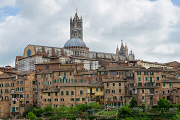 Fototapeta na wymiar SIENA, ITALY - APRIL 26, 2019: View to the old town in Siena, Italy