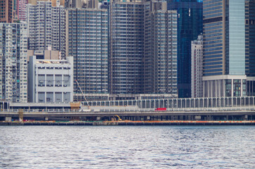 Boat and ship traffic in bay of Victoria Harbor Hong Kong, China with city skyline in background...