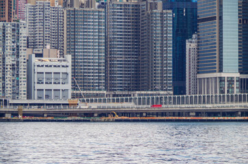 Boat and ship traffic in bay of Victoria Harbor Hong Kong, China with city skyline in background...