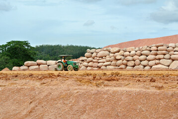 Stone boulders are stacked on the ground and used as retaining walls. It acts to resist soil...