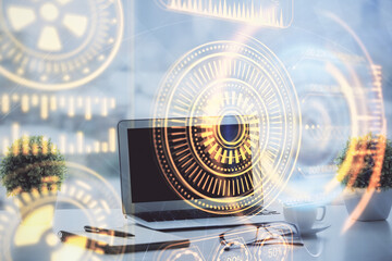Computer on desktop in office with technology theme hologram. Double exposure. Tech concept.