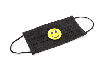 Mask and smiley sign on white background