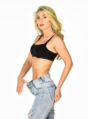 Impressive result. Girl shows big size of her pants and slim belly. Slim fit woman denim pants. Girl on diet lost weight white background. Loss weight concept. Healthy lifestyle. Dieting and fitness