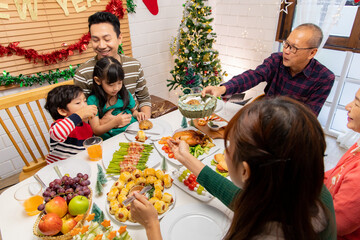 Thanksgiving or christmas Celebration Asian  Family Dinner Concept.Happy family having holiday dinner. father mother and daughter, having dinner at home. elderly parents during the celebration .