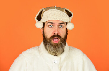 Before Christmas. portrait of trendy guy wearing hat. Male winter style. Modern winter earflap beanie hat. Funky surprised bearded man. mature man posing with funny outfit. man beard in winter hat © be free
