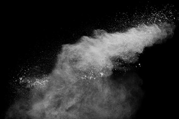 White powder explosion clouds.Freeze motion of white dust particles splash on black background.
