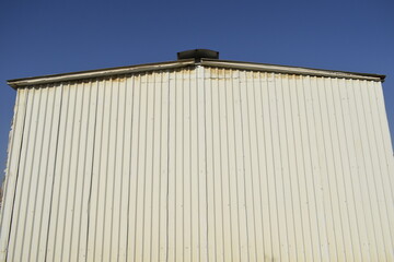 a sandwich panel of insulation on the wall. Construction of a new industrial building. Industrial warehouse construction and outdoor view of the roof ceiling structure. Muscat, Oman